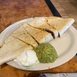a plate of quesadillas and guacamole