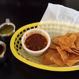 Tomato salsa with flour tortilla chips and two taco sauces