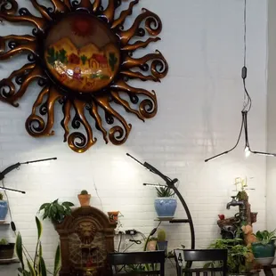 Plants, two bubbling fountains, ceramics and this gorgeous giant sun!