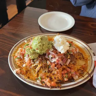 Nachos supreme with shredded beef and chicken