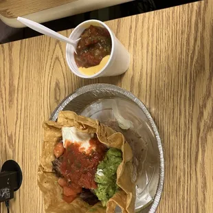 Taco salad to go with cheese sauce, red salsa and salsa picante.