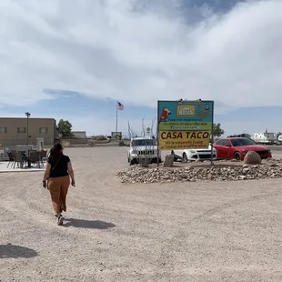 two people walking in a parking lot