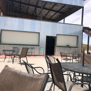 tables and chairs outside a building