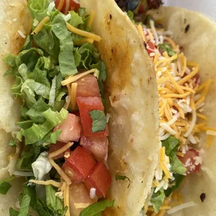 two tacos on a white plate