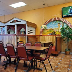 a dining area with tables and chairs
