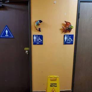 a yellow caution sign in front of a door