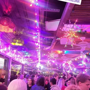 a crowd of people walking through a store