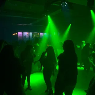 a group of people dancing at a nightclub
