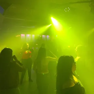 a group of people dancing in a club