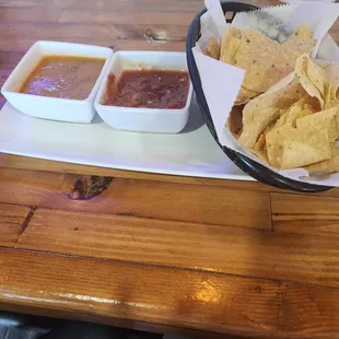 a tray of chips and salsa on a table