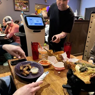 a man serving food at a restaurant