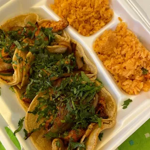 a plate of tacos and rice