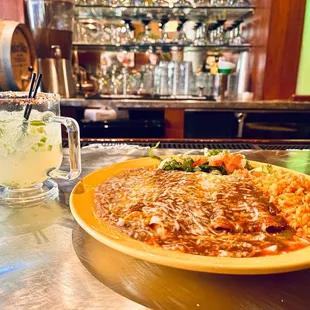 a plate of mexican food and a drink