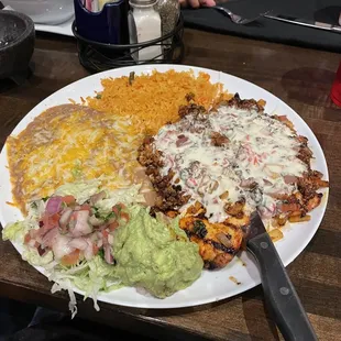 Chori Pollo with a side of guacamole, rice and beans.