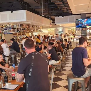 people sitting at tables in a restaurant