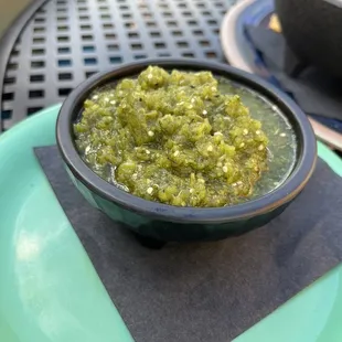 a bowl of salsa on a plate