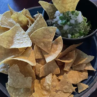 Fresh guacamole and chips - avocado, onion, cilantro, lime