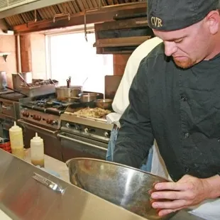 a chef preparing food in a commercial kitchen