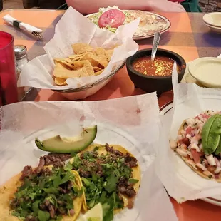 Steak tacos, shrimp tostada, and burrito