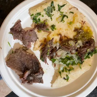 Barbacoa taco served with a big piece of fat tendon instead of meat.