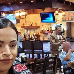 Servers, patrons, and live mariachi singer.