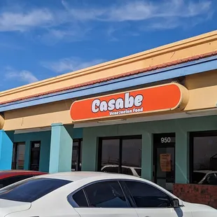 cars parked in front of a restaurant