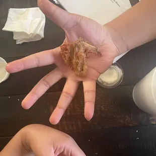 two hands holding a donut