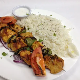 Chicken Kabob Entree comes with Rice, Salad and a side of Hummus and pita bread.