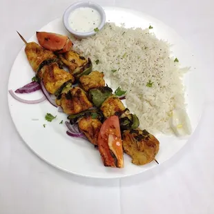 Chicken Kabob Entree comes with Rice, Salad and a side of Hummus and pita bread.