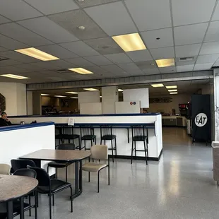 a cafeteria with tables and chairs