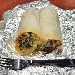 Breakfast Burrito with egg, cheese, bacon, grilled onions, green peppers, mushrooms, and ranch dressing.