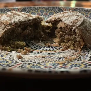 B'stilla. Saffron chicken almonds in phyllo. Topped with cinnamon sugar