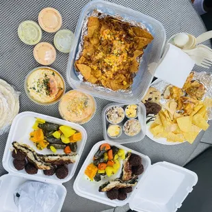 a variety of food in containers on a table