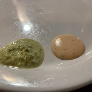 Trying the condiment sauces that they offer.  The green one was spicy and the the orange one was more yogurt based.