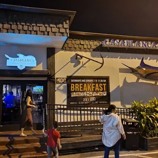 a woman and a child outside a restaurant