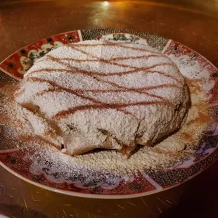 No idea what this is called. Phyllis dough filled with ground meat and covered with nutmeg and powdered sugar.