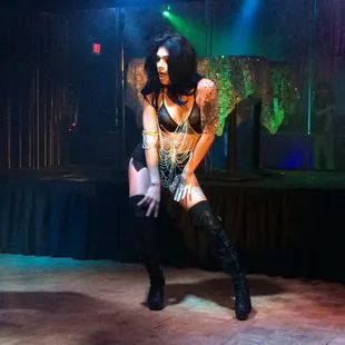 a woman dressed in lingerie and thigh high boots