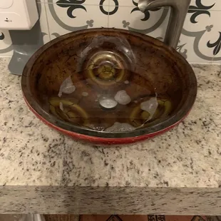 Community sink sitting with water in hallway. Gross to see and concerning if this is the sink employees are encouraged to use.