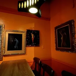 a dining room with paintings on the wall
