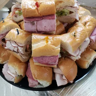 a pile of sub sandwiches