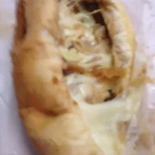 A piece of my cheesesteak w/melty yummy cheese. Sooooo good!!