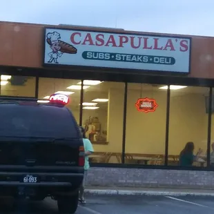 a truck parked in front of a restaurant