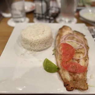 a plate of fish and rice