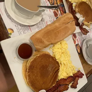 Pancakes, eggs, bacon, toast, and cafe con leche