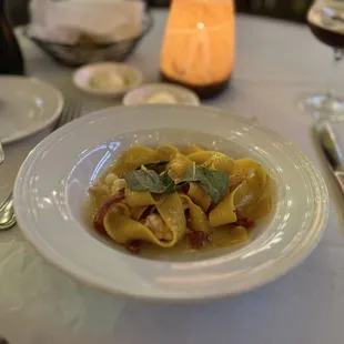 a plate of pasta and a glass of wine