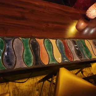 a row of colorful tiles on a bar
