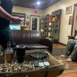 a man sitting on a couch with a glass of whiskey