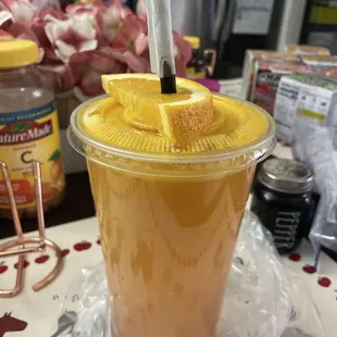 Fresh squeezed orange juice garnered with a slice of orange on top!