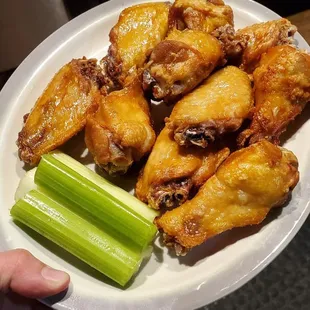 a plate of wings and celery