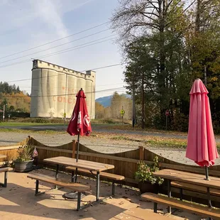 a patio area with tables and umbrellas